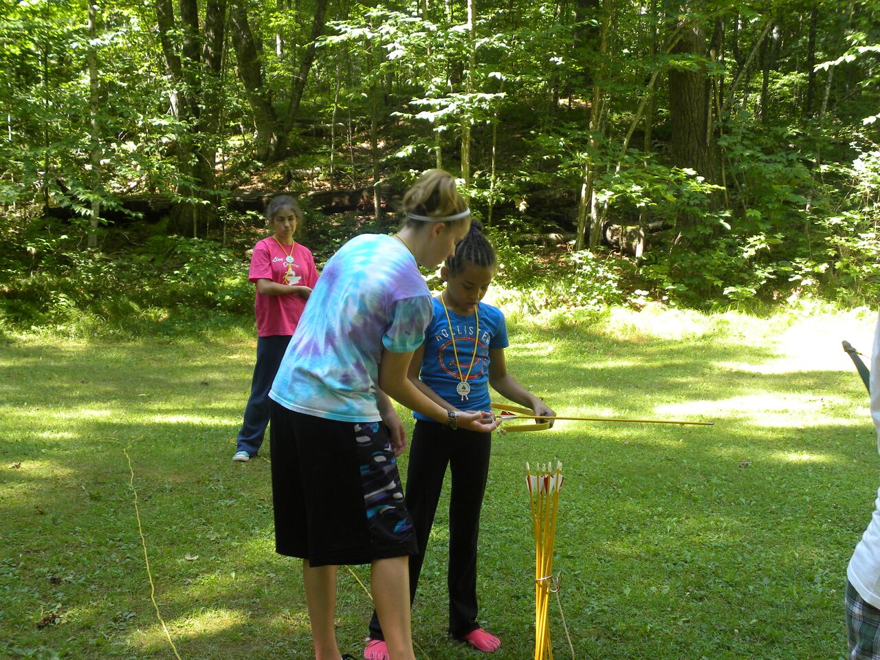 Counselors teaching campers the art of archery at Camp WeHaKee