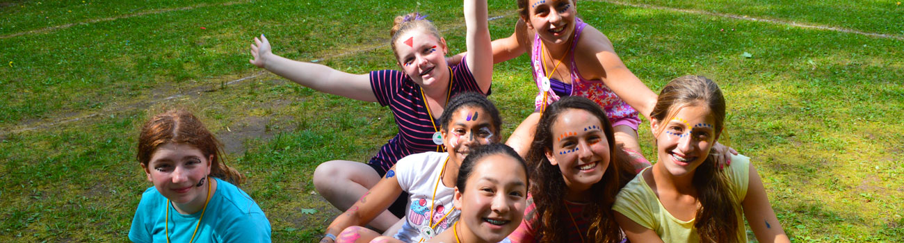 Happy campers with painted faces at WeHaKee Camp for Girls