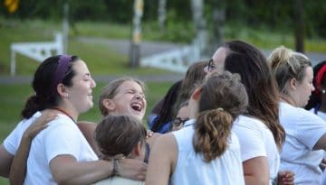 Staff and campers at WeHaKee Camp for Girls giving a big group hug.