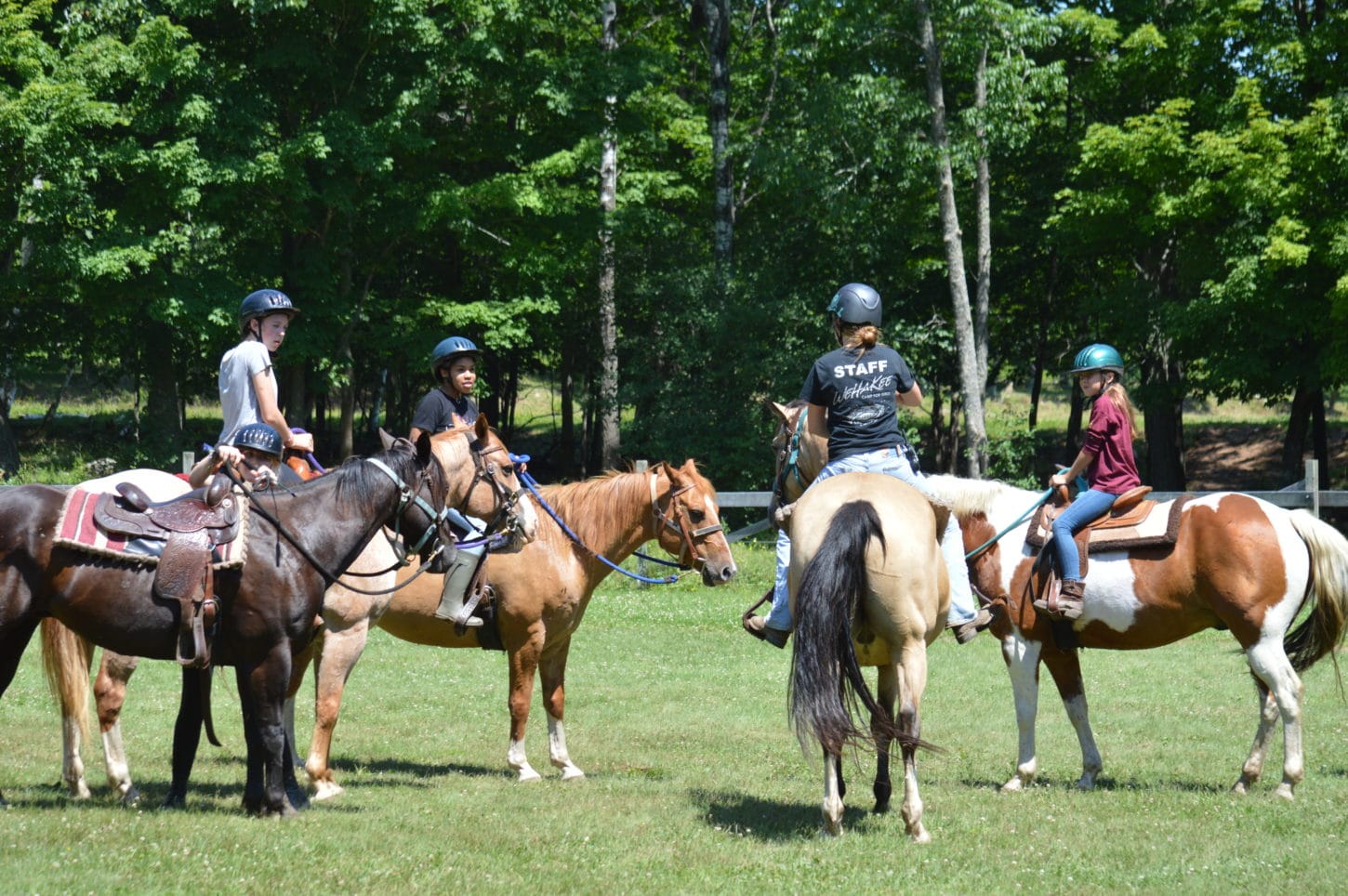 WeHaKee Camp for Girls staff and campers horseback riding.