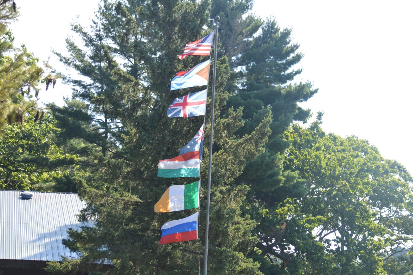 Country flags on a flag pole at WeHaKee Camp for Girls.
