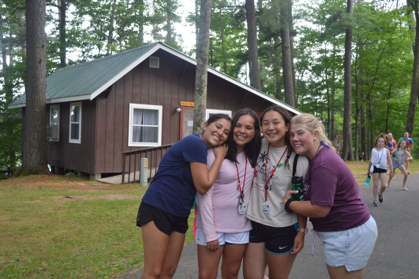 WeHakee Camp for Girls staff group photo in front of cabin.