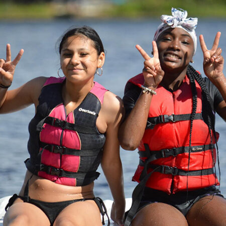 wehakee-camp-for-girls-campers-lifejackets-hunter-lake-day-peace-signs-friendship-2024-winter-wisconsin