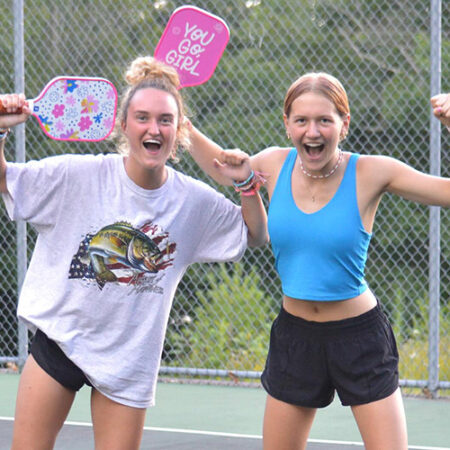 wehakee-camp-for-girls-campers-picklball-you-go-girl-paddles-victory-pose-courts-outdoor-activity-2024-winter-wisconsin