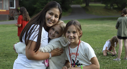 wehakee-camp-for-girls-ana-associate-director-campers-hugging-happy-summer